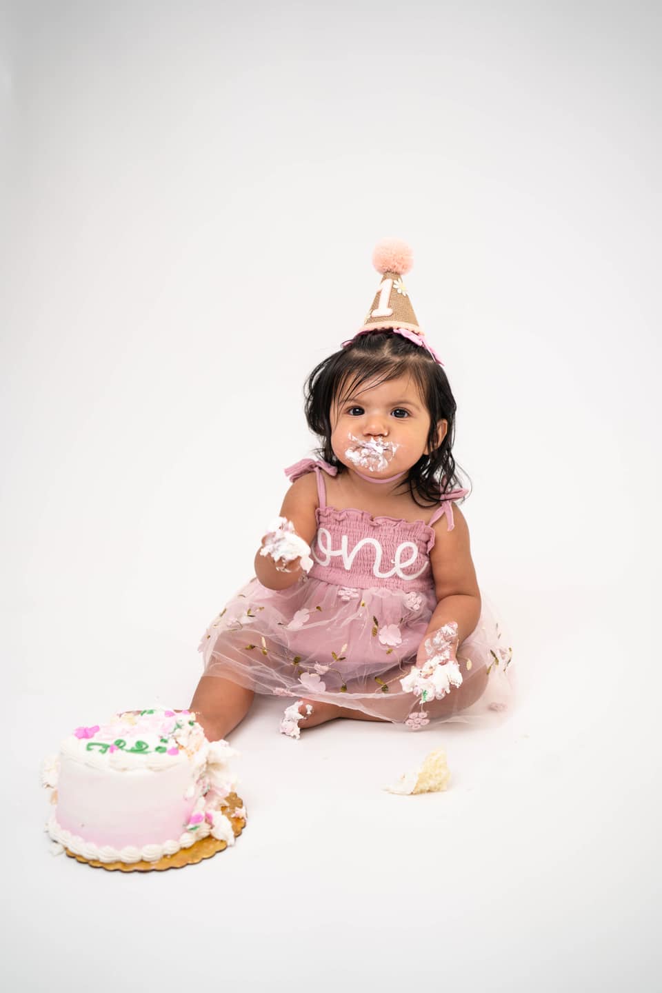 Child celebrating a milestone birthday during a Solano County cake smash session.