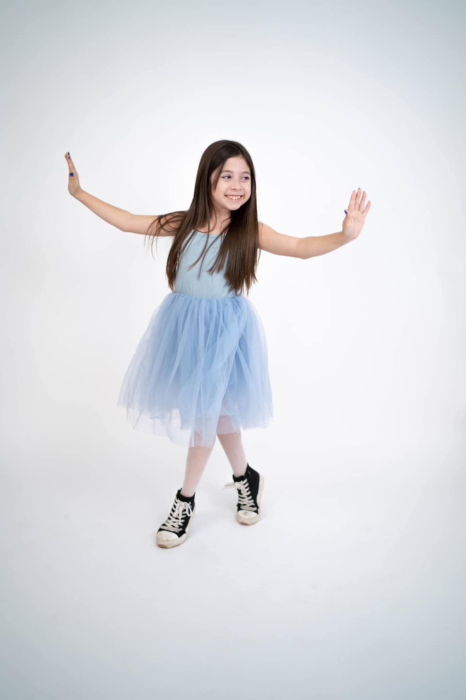 Child smiling during a playful family portrait session in Vacaville.